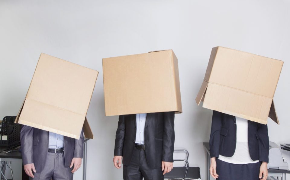Moving problems force business people to cover their heads with cardboard boxes